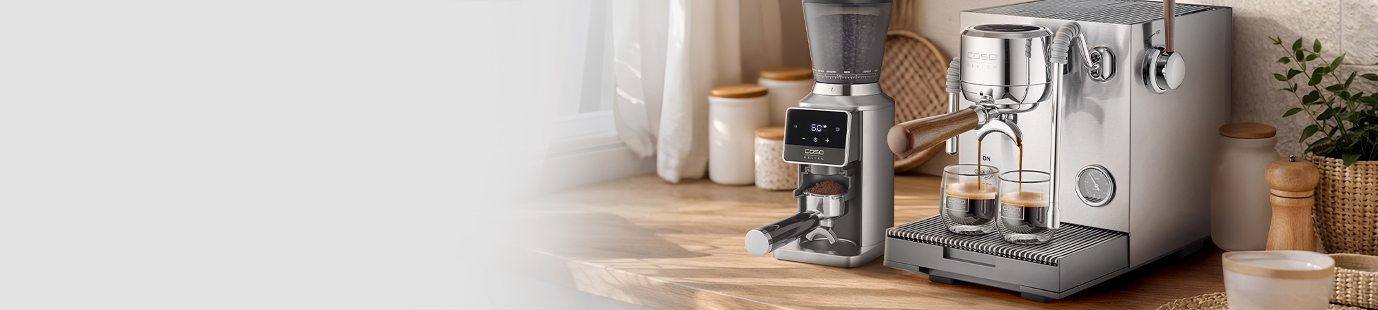 Espresso machine and grinder on a wooden counter with coffee cups