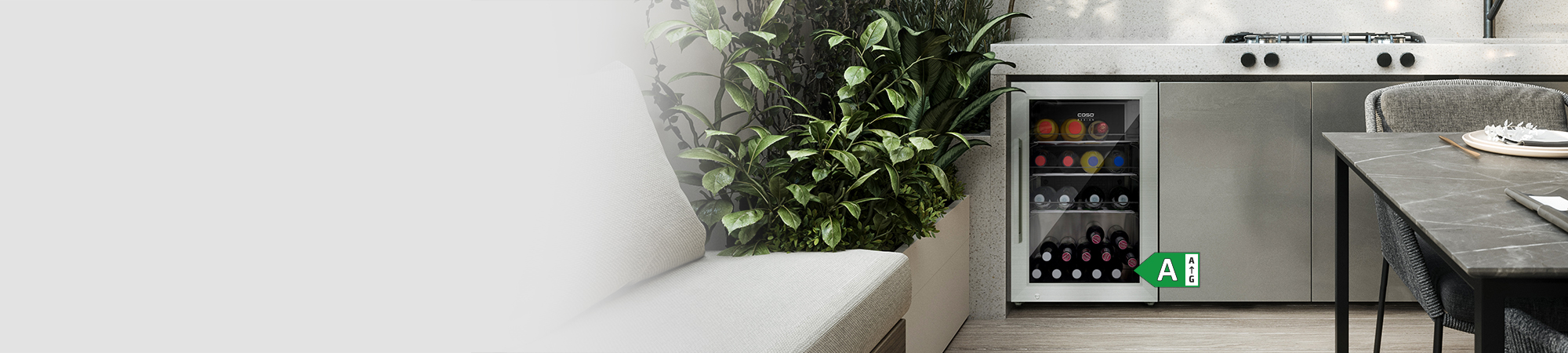 Outdoor kitchen with wine cooler, plants, and dining table with chairs.