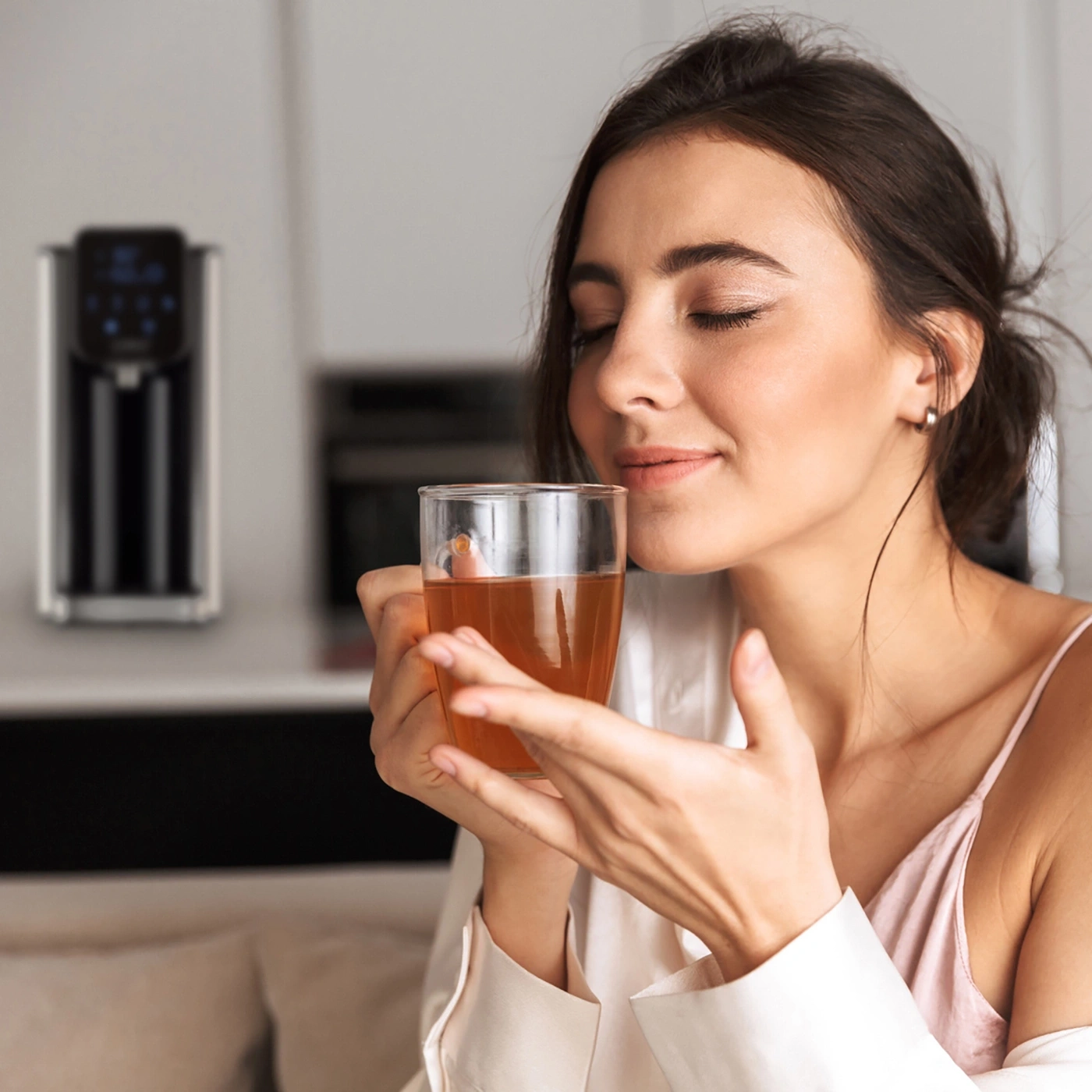 Woman drinking tea, relaxed, eyes closed, kitchen, close-up, happy, enjoying