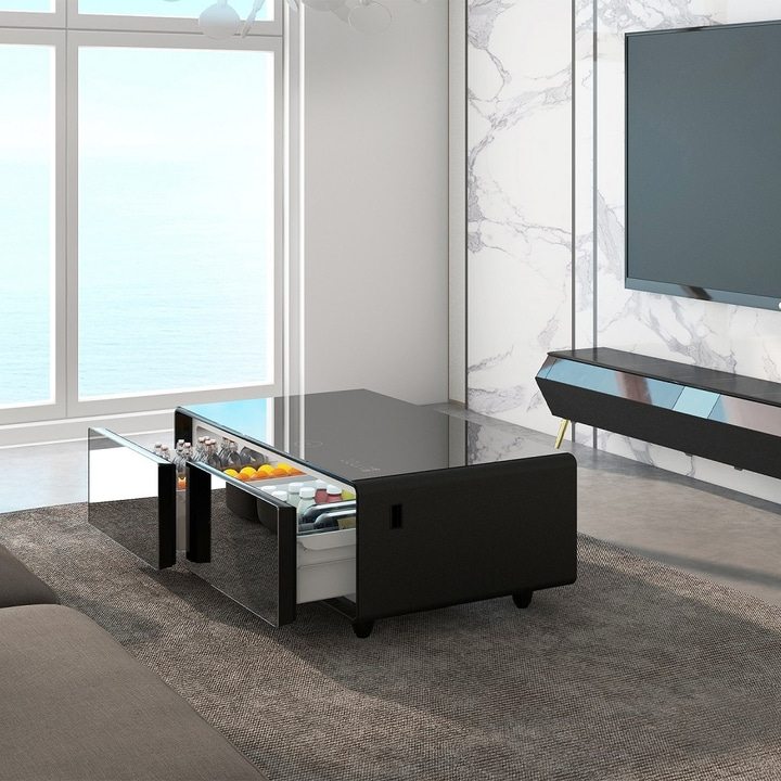 Black coffee table with fridge, drinks and fruit in a modern living room