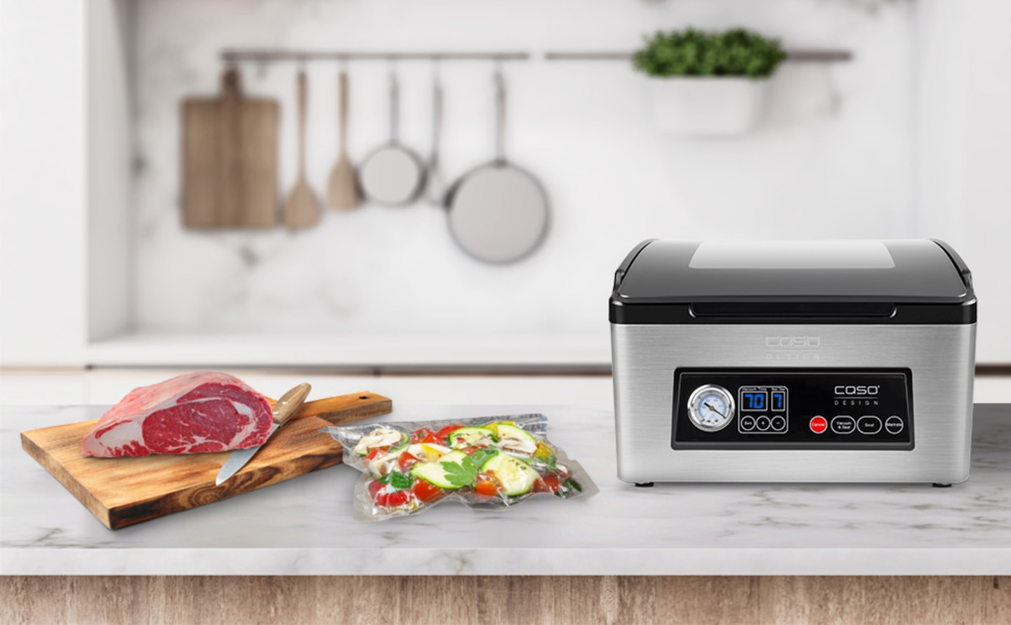 A vacuum sealer with meat and vegetables on a kitchen countertop.