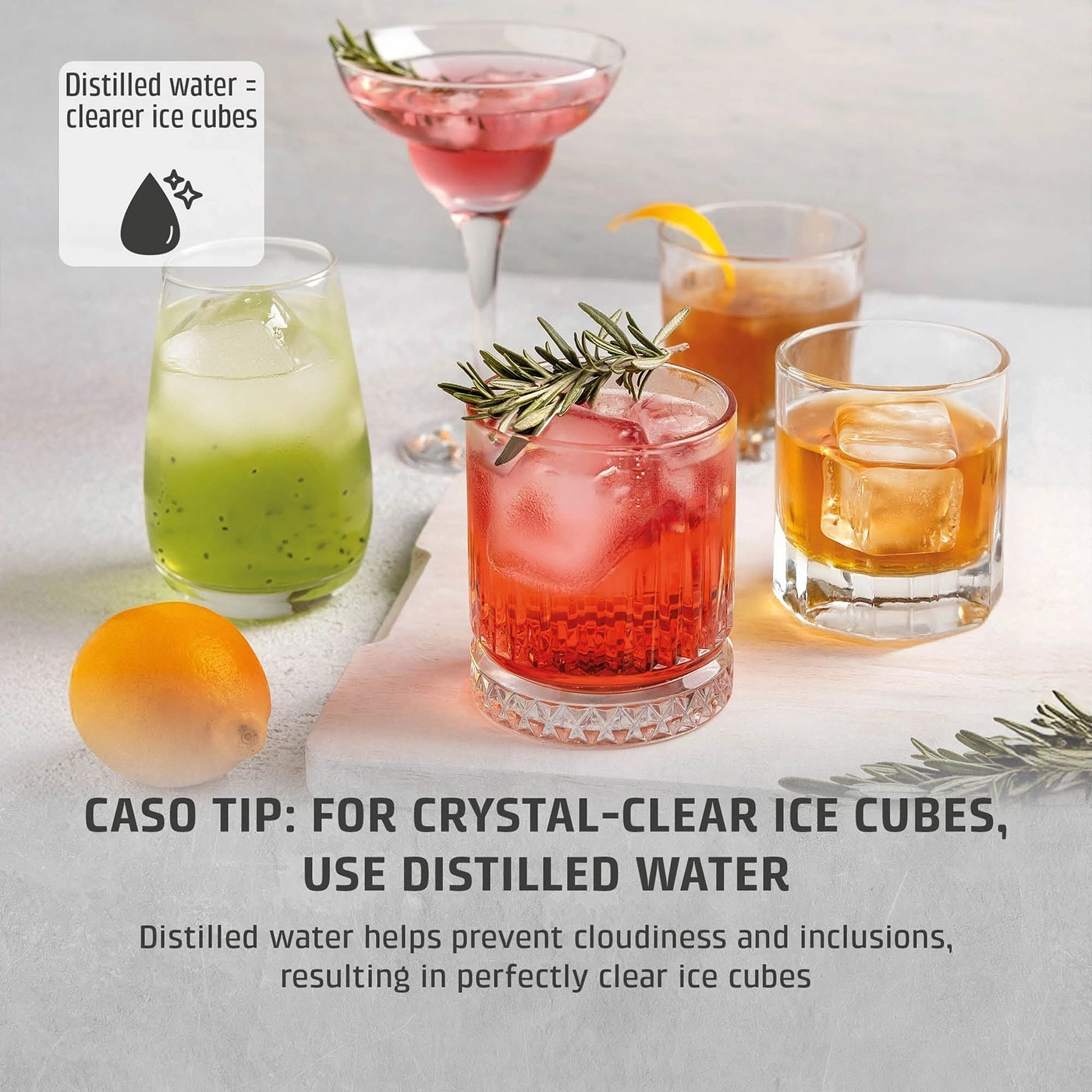 Several cocktails with clear ice cubes and lemon