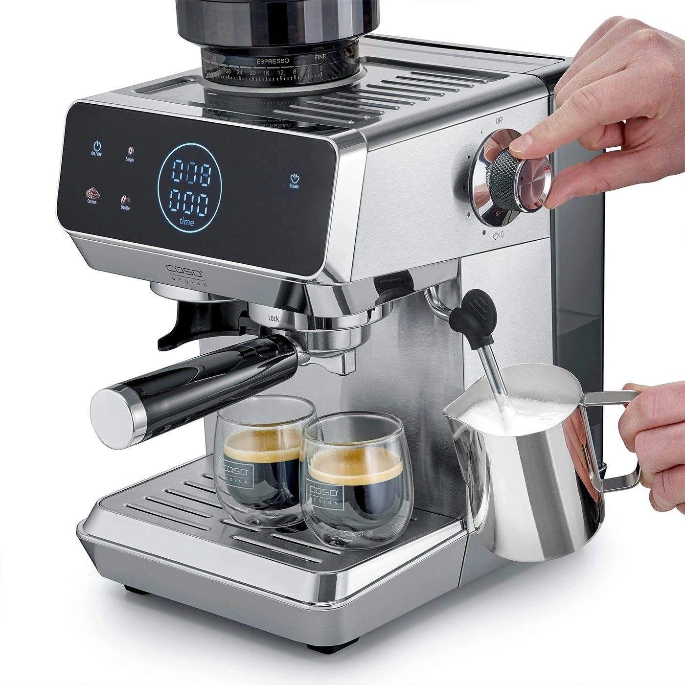A person steams milk for an espresso with a coffee machine.