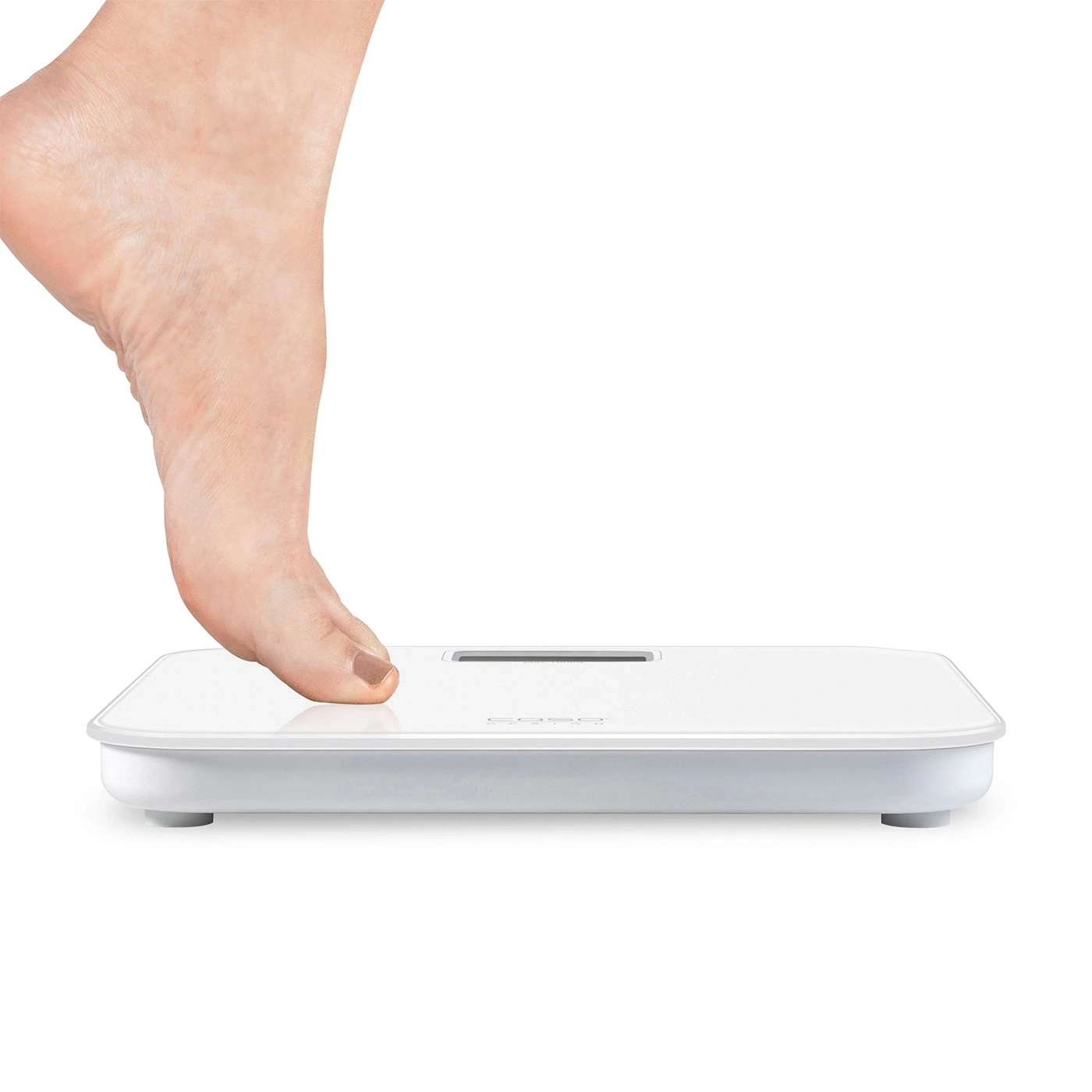 Foot on a white scale. Person weighing themselves. Health and fitness.