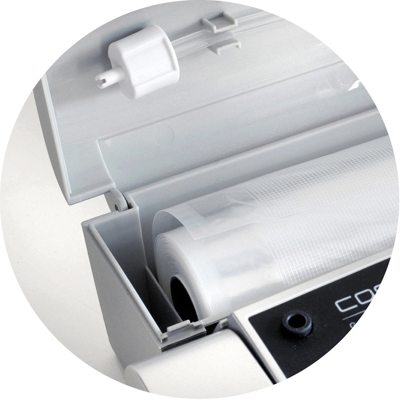 Grey vacuum sealer with open cover and a roll of plastic film