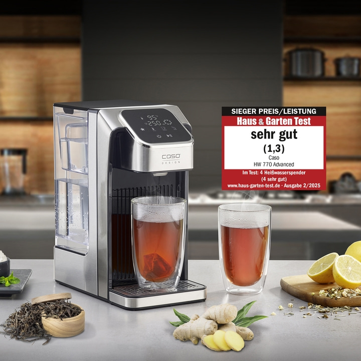 Tea machine with two glasses of tea, ginger, lemon and award.