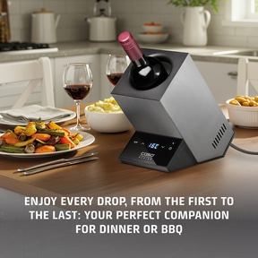 Wine bottle in a cooler on a table with food and text.