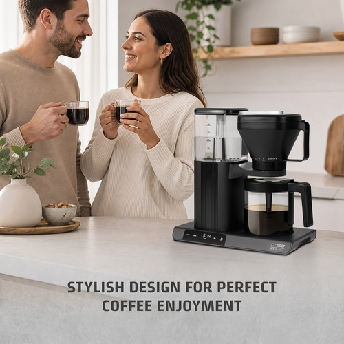 A couple enjoys coffee next to a stylish coffee maker on a kitchen countertop.