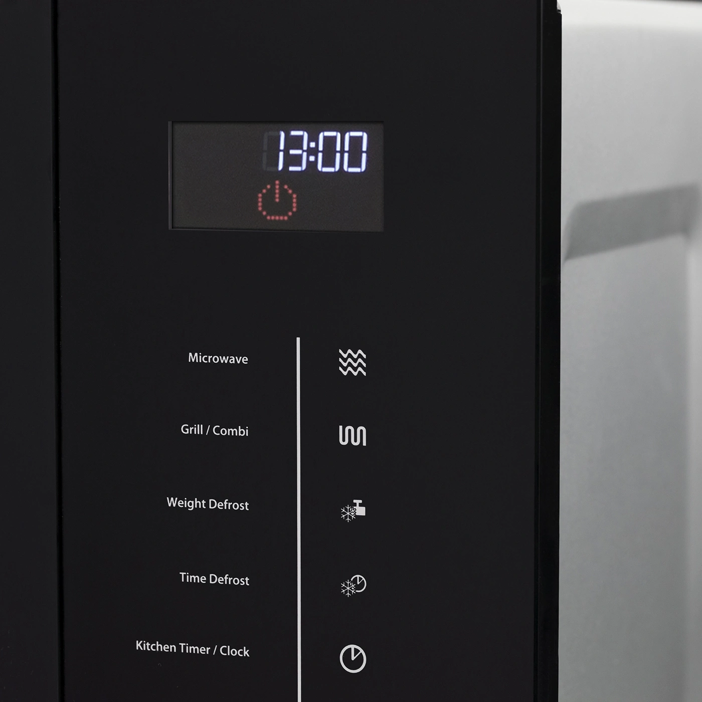 Microwave with control panel and digital display showing the time 13:00.