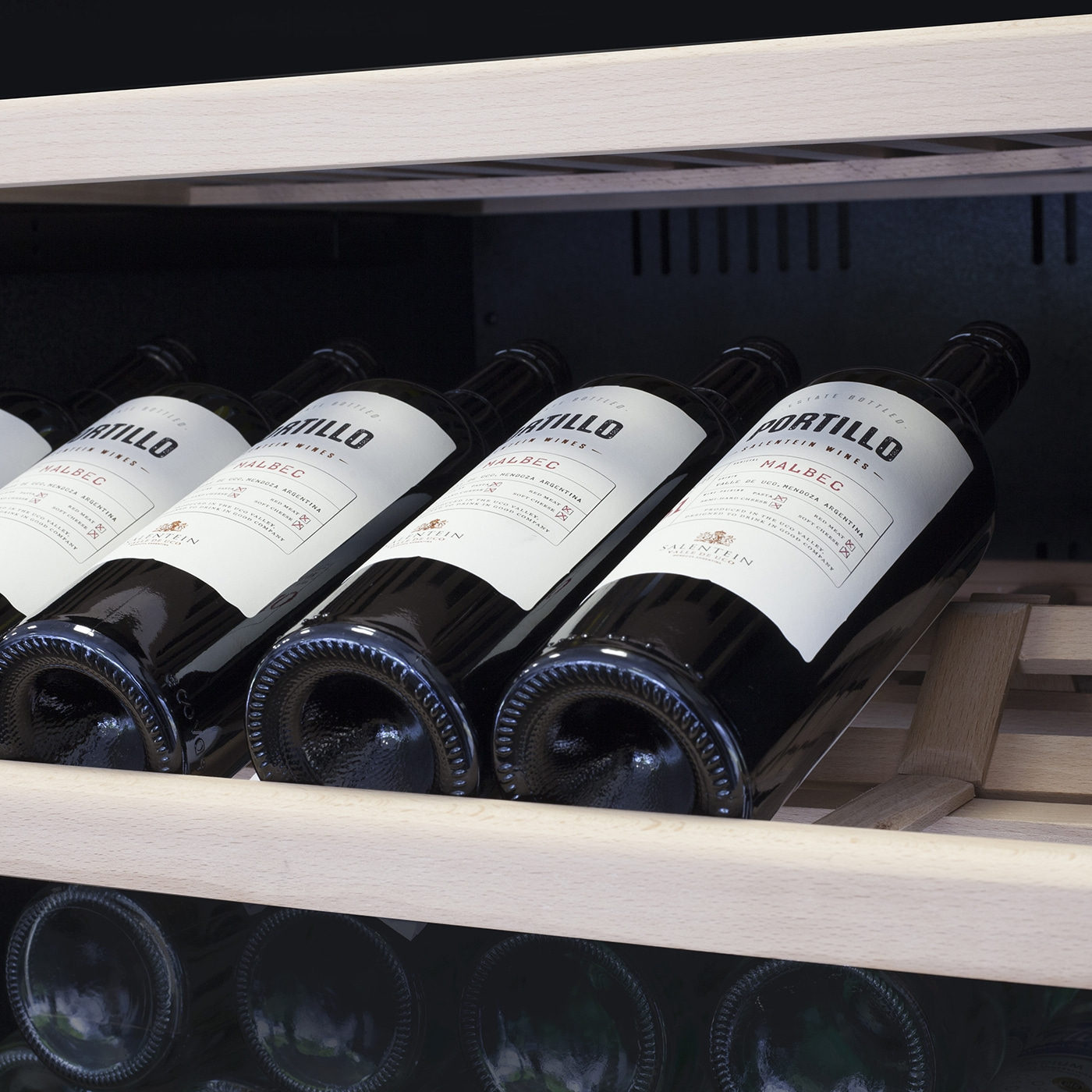 Weinregal mit Flaschen, die mit 'Malbec' beschriftet sind, in einem Weinkühler.