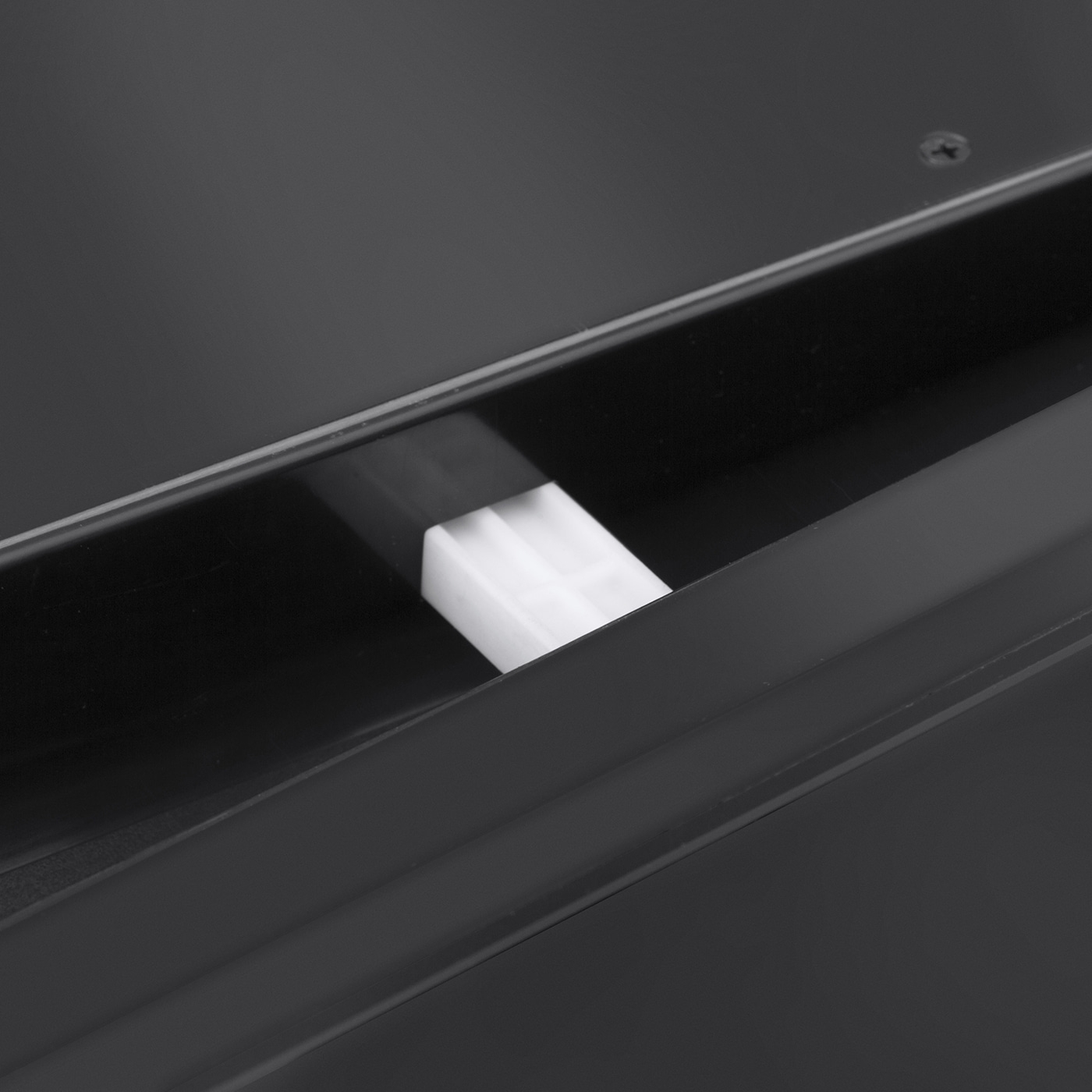Close-up of a black object with a white rectangular part