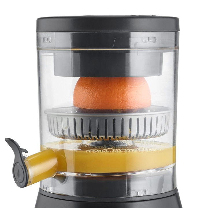 Electric juicer with orange, juice, and spout. Transparent container. Black and silver.