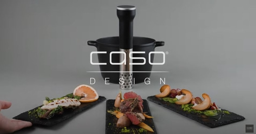 Sous vide machine with food on slate plates, CASO Design