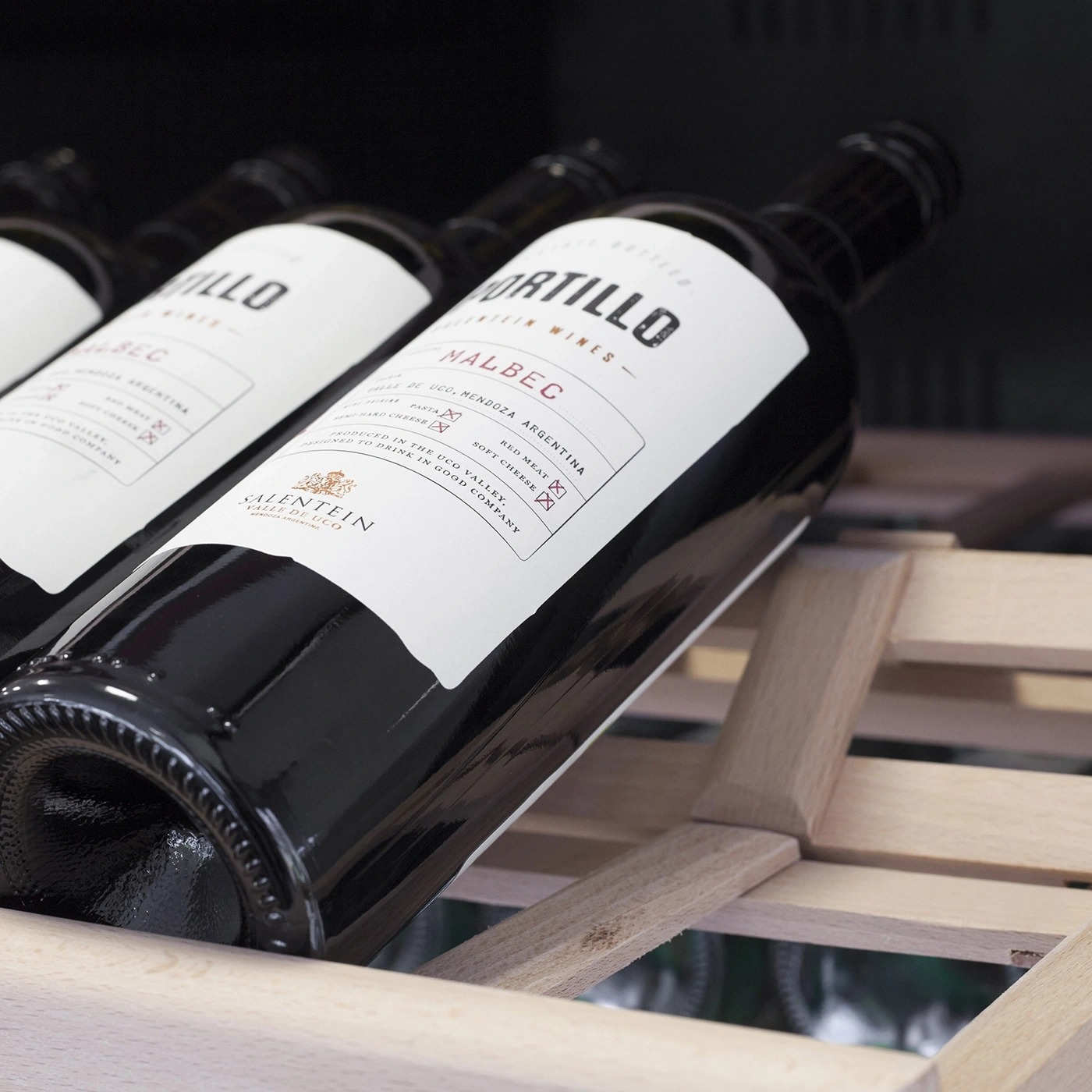 Bottles of wine on a wooden shelf
