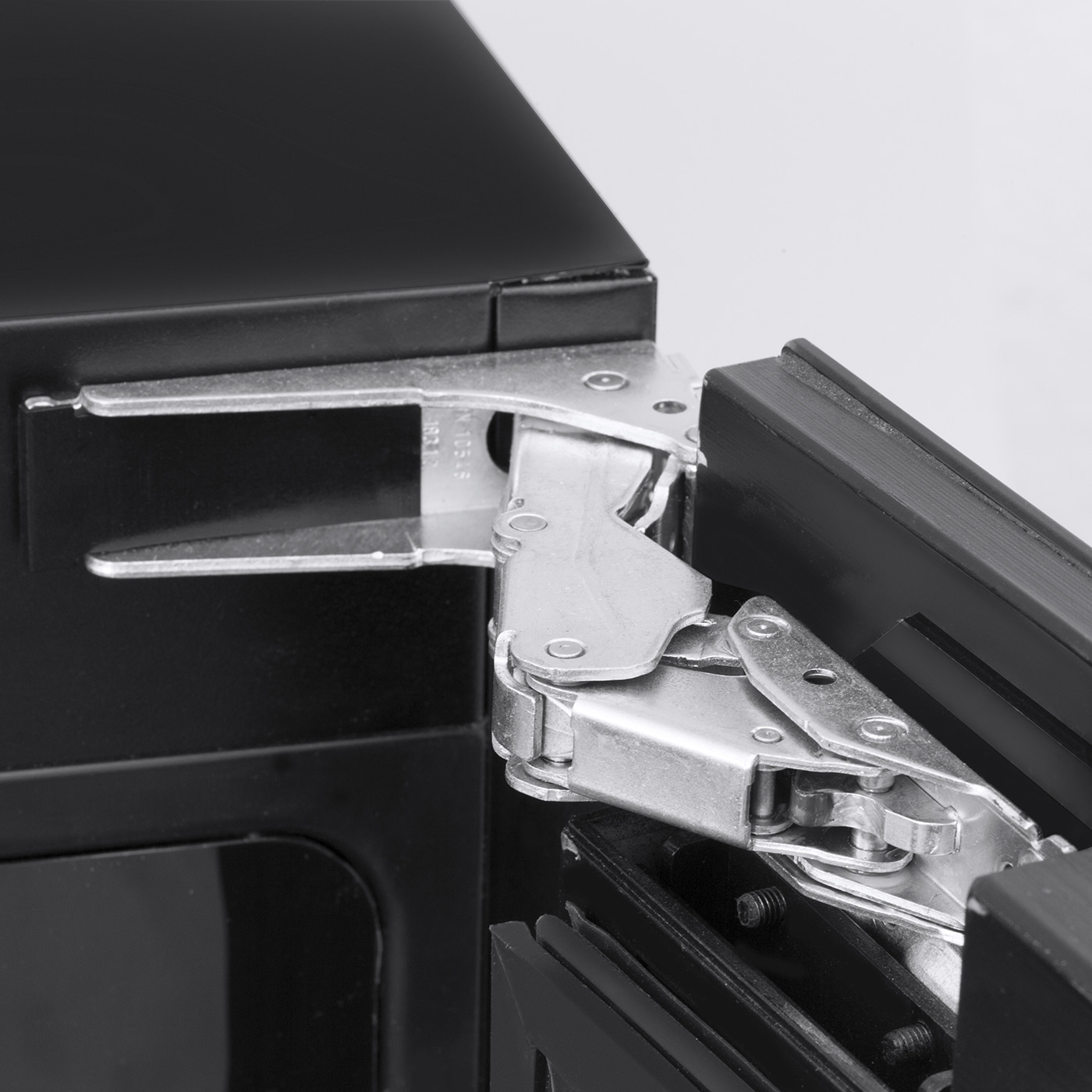 Black cabinet with silver hinge attachment, close-up, detail shot, metal