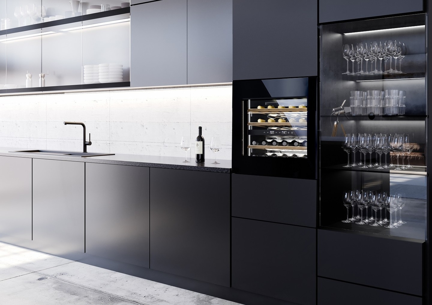 Modern kitchen with wine cooler, glasses, and bottle. Black cabinets and countertop.