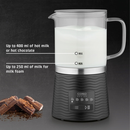 Milk frother with milk, chocolate and text. Hot milk and milk foam.