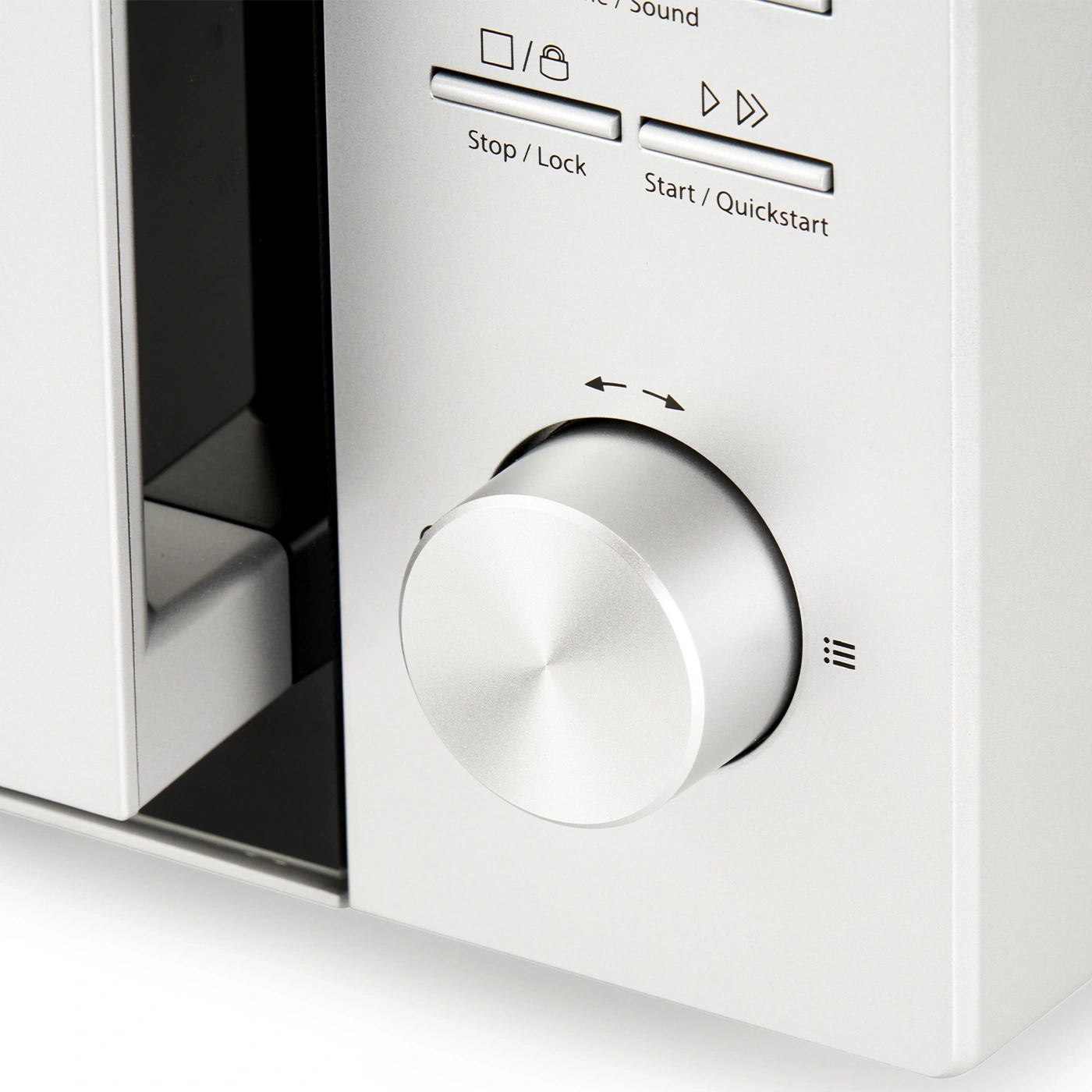 Microwave with dial and buttons. Silver design. Close-up shot.
