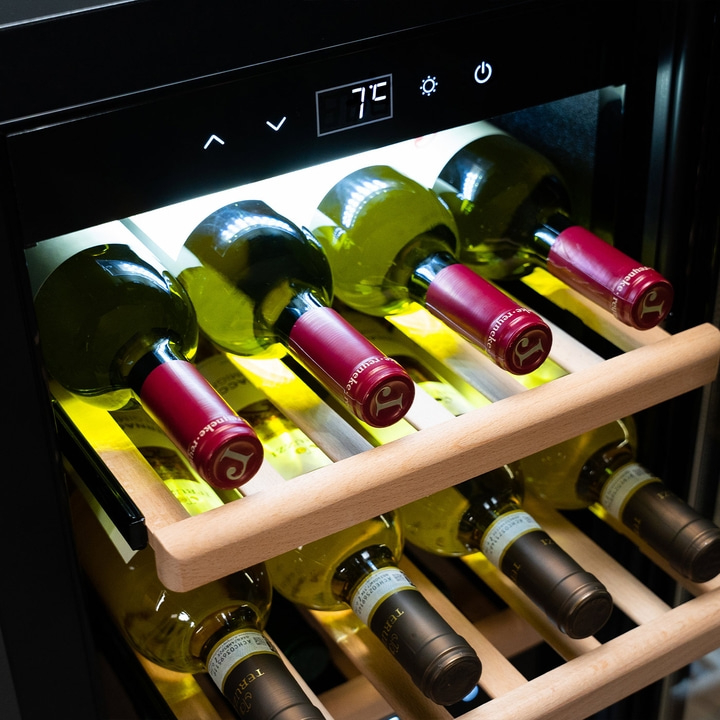 Wine cooler with bottles, temperature display, wooden racks, and red capsules