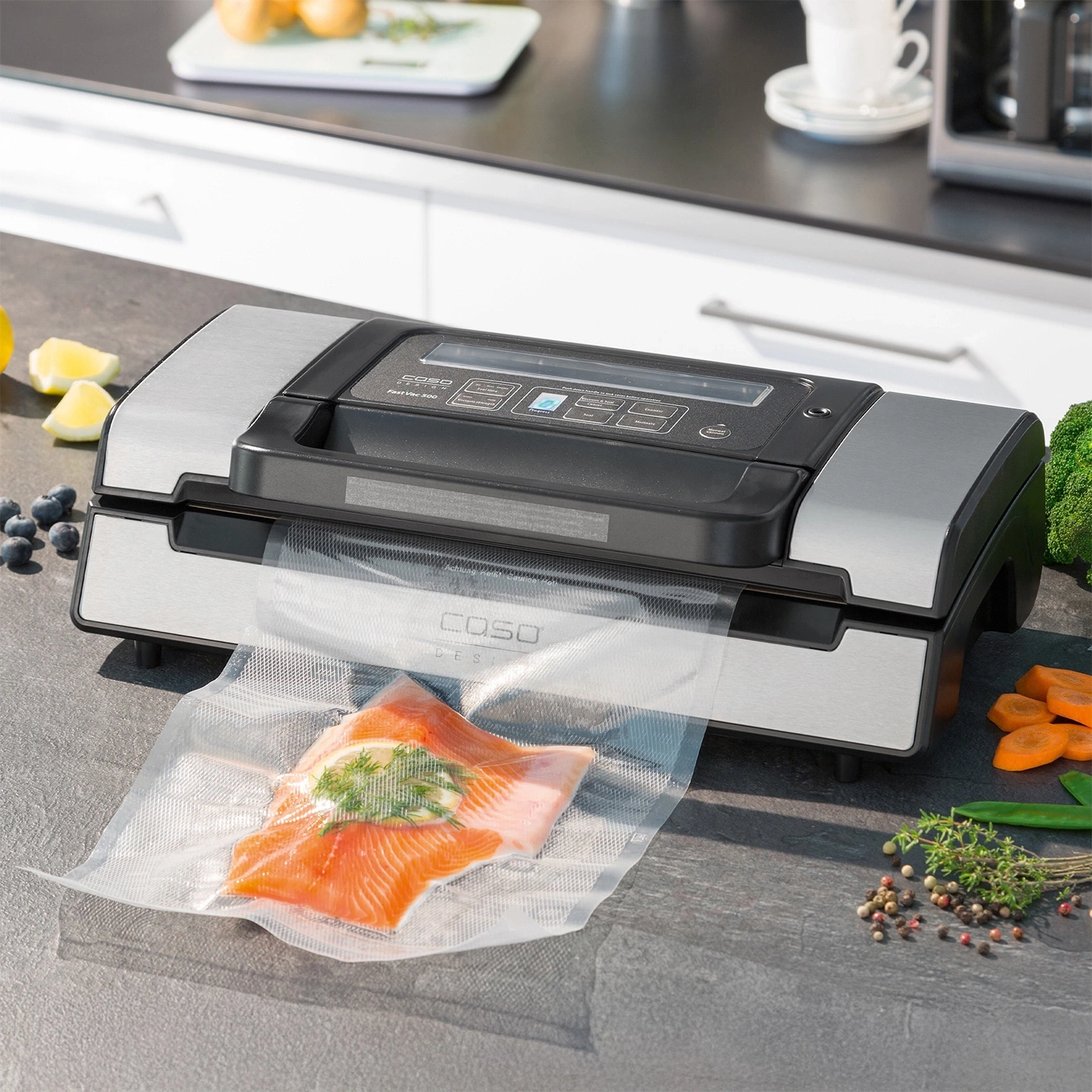 Vacuum sealer with salmon in a bag on a kitchen countertop.