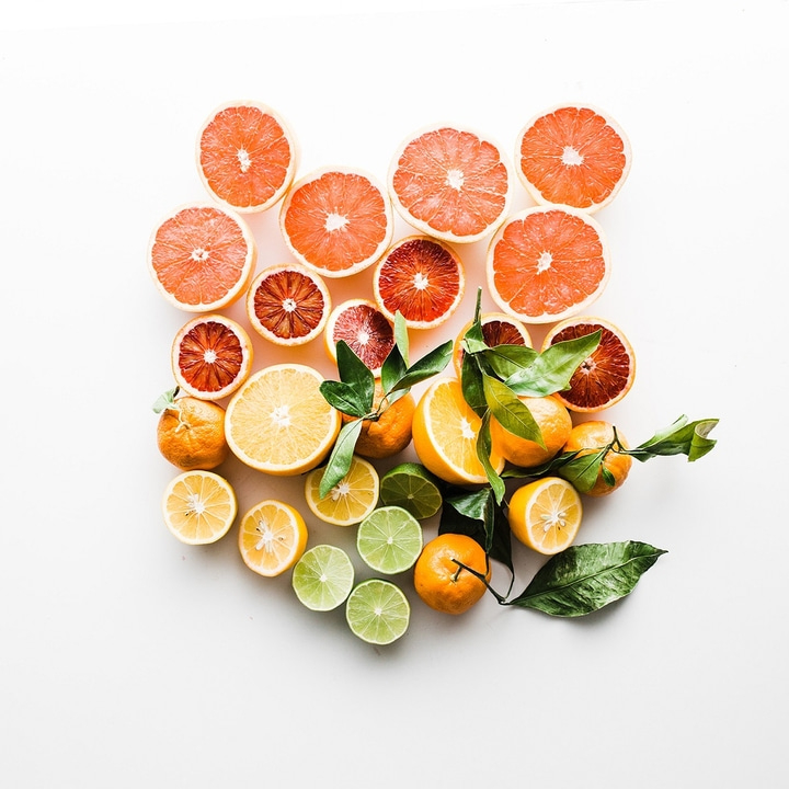 Citrus fruits, grapefruits, oranges, lemons, and limes on a white background