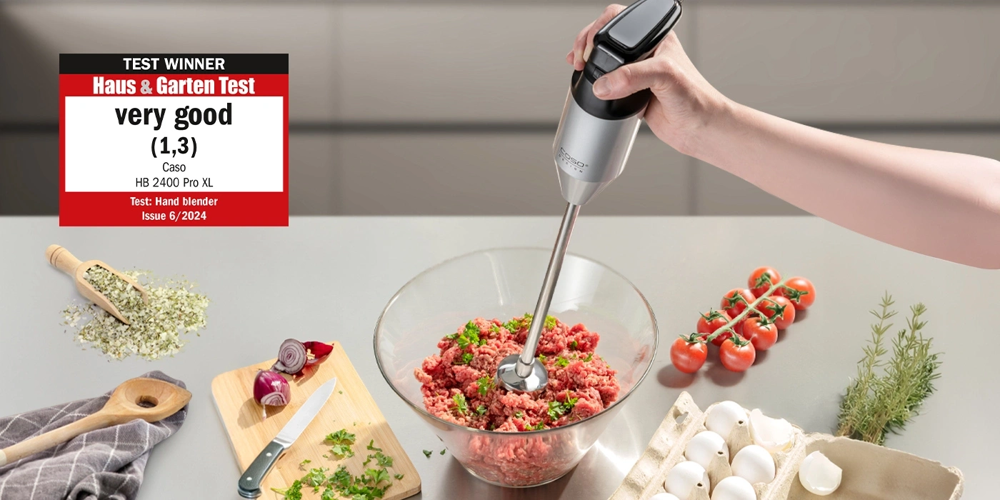 Hand blender in use, with ingredients like minced meat, tomatoes, and eggs.