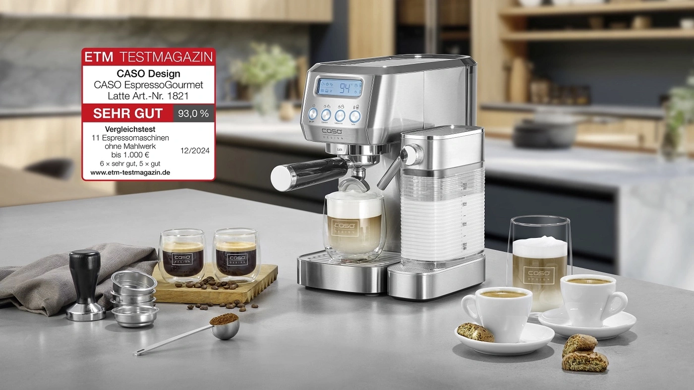 Espressomaschine mit Bewertung, Kaffeetassen und Zubehör auf einer Arbeitsplatte.