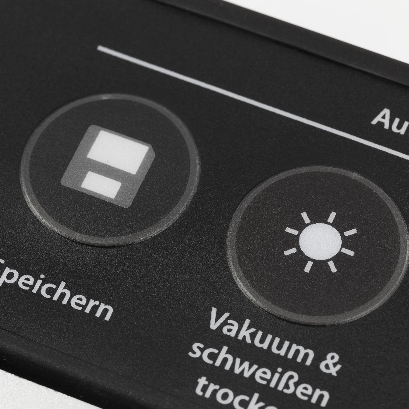 Black control panel with symbols and text, vacuum and sealing.
