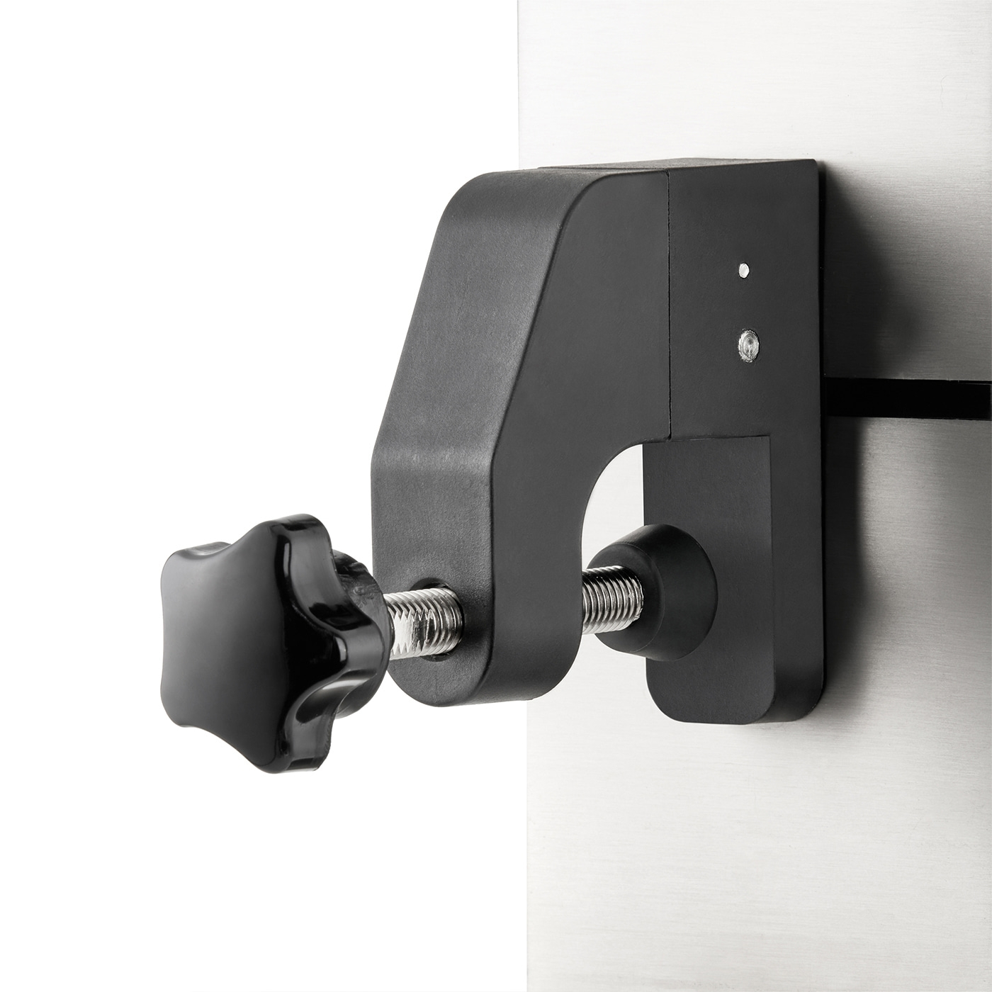 Black clamp with screw attached to a metal plate. Close-up shot, isolated.
