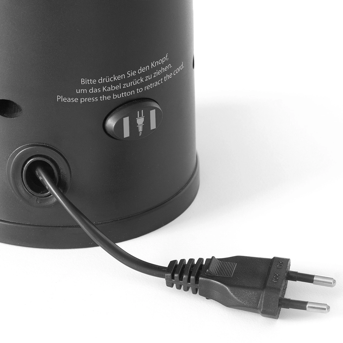 Schwarzes Gerät mit Kabel und Knopf zum Einziehen.