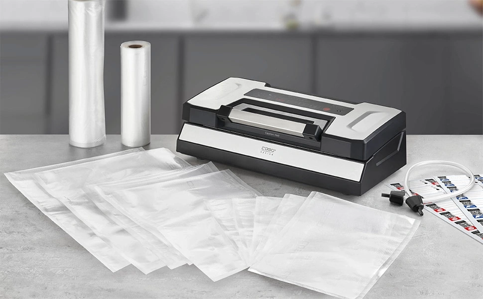 Vacuum sealer with bags and rolls on a work surface