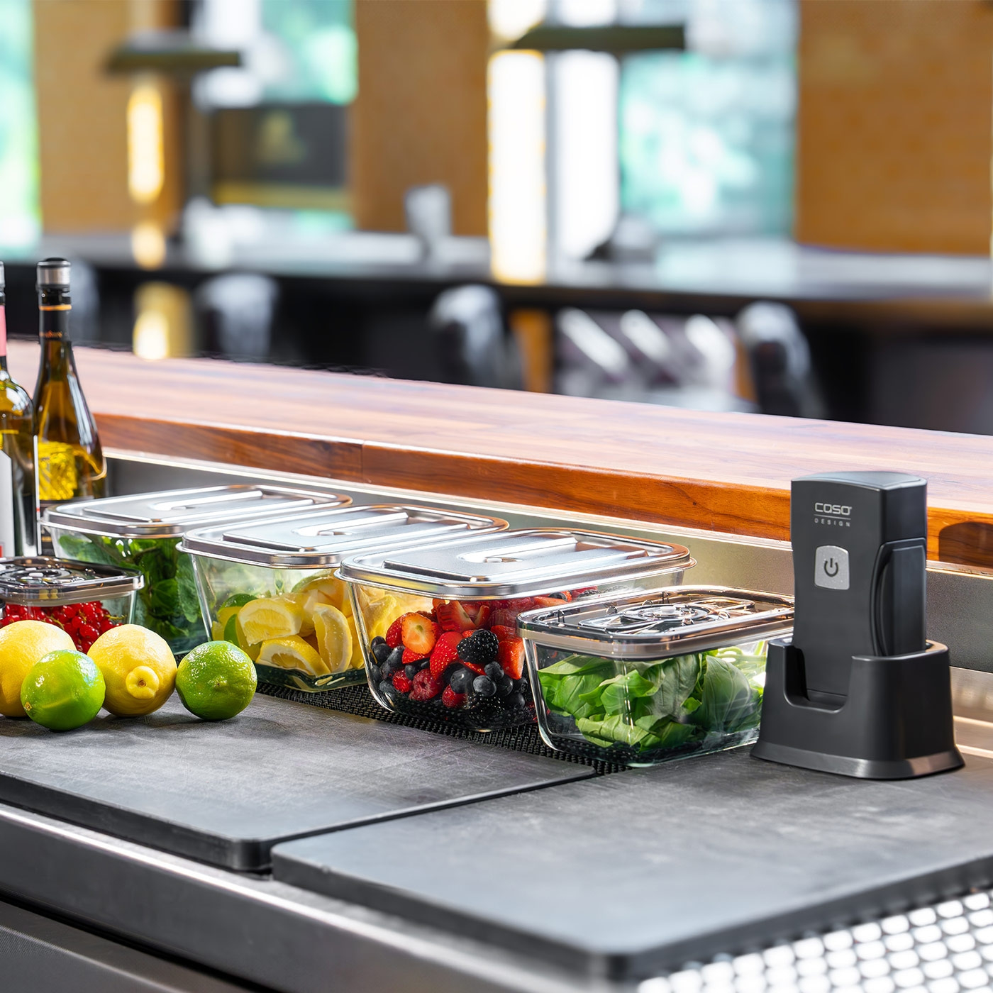 Fruits and vegetables in glass containers on a counter with a vacuum sealer.