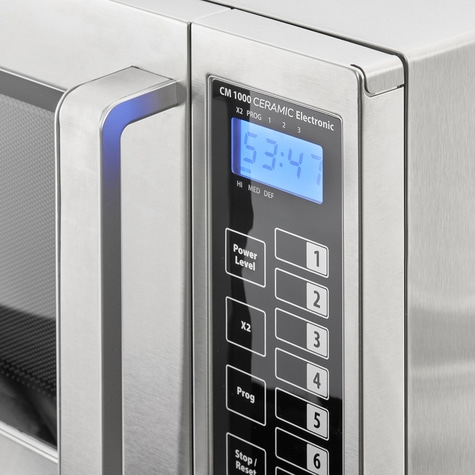 Microwave with control panel and digital display showing 53:47 time.