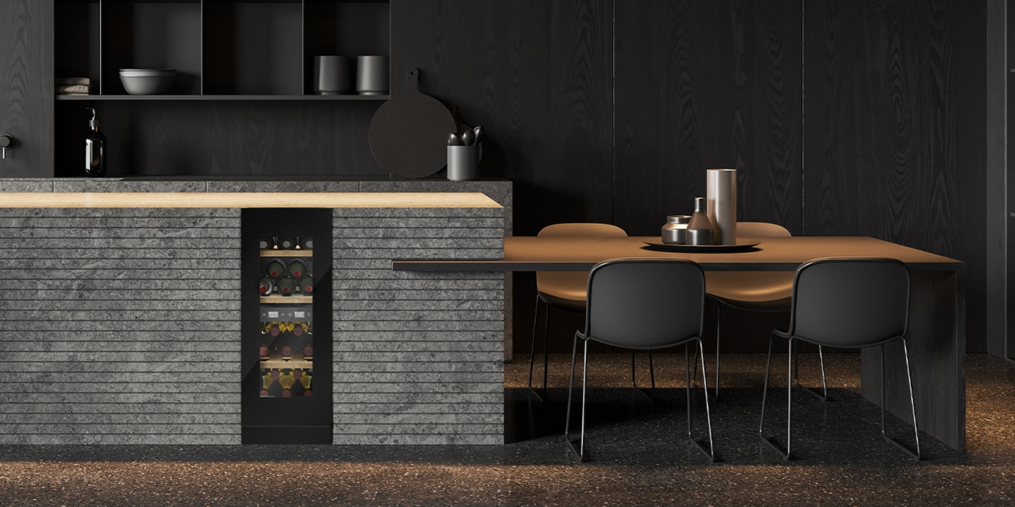 Dark kitchen with wine cooler and dining table with chairs
