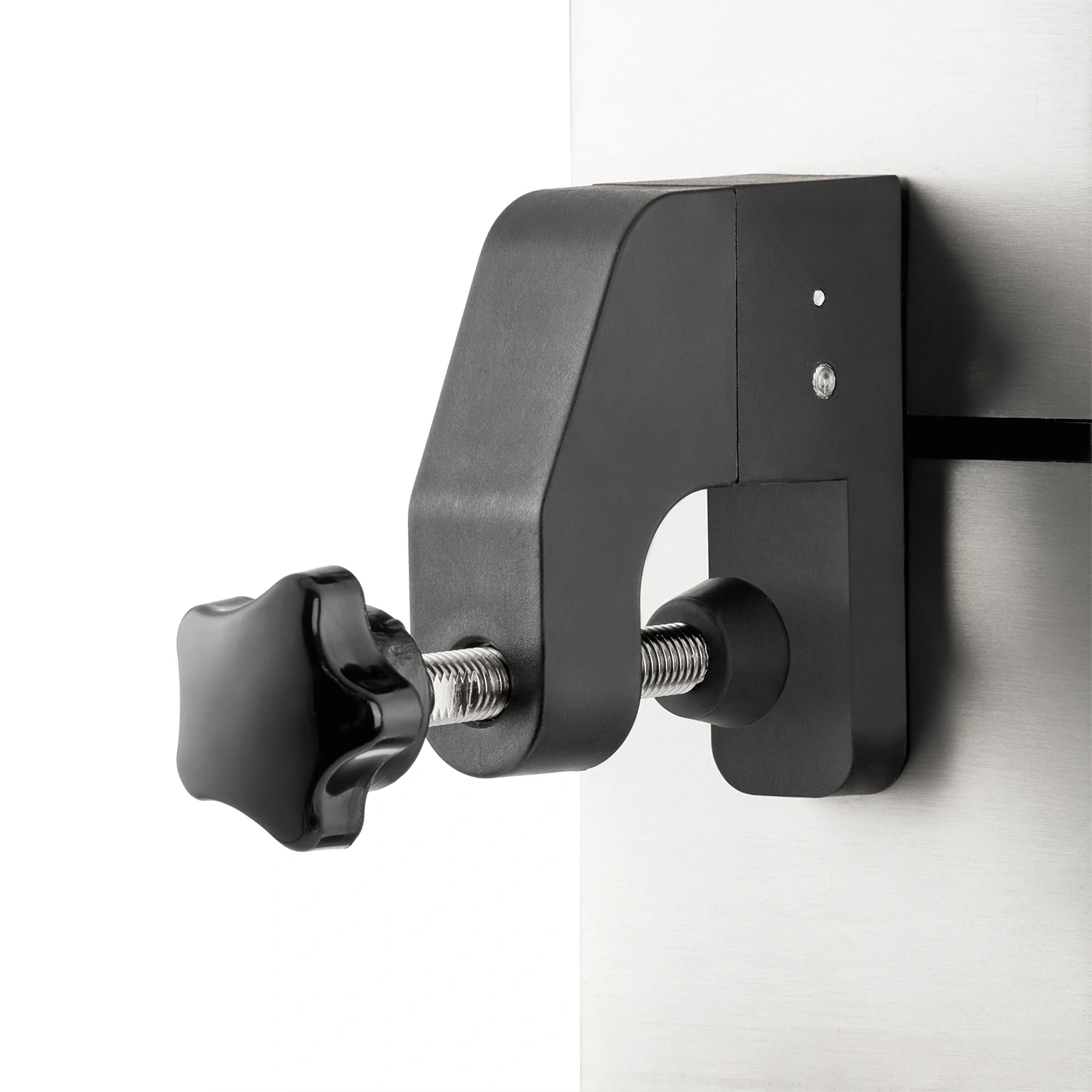 Black clamp with screw attached to a metal plate. Close-up shot, isolated.