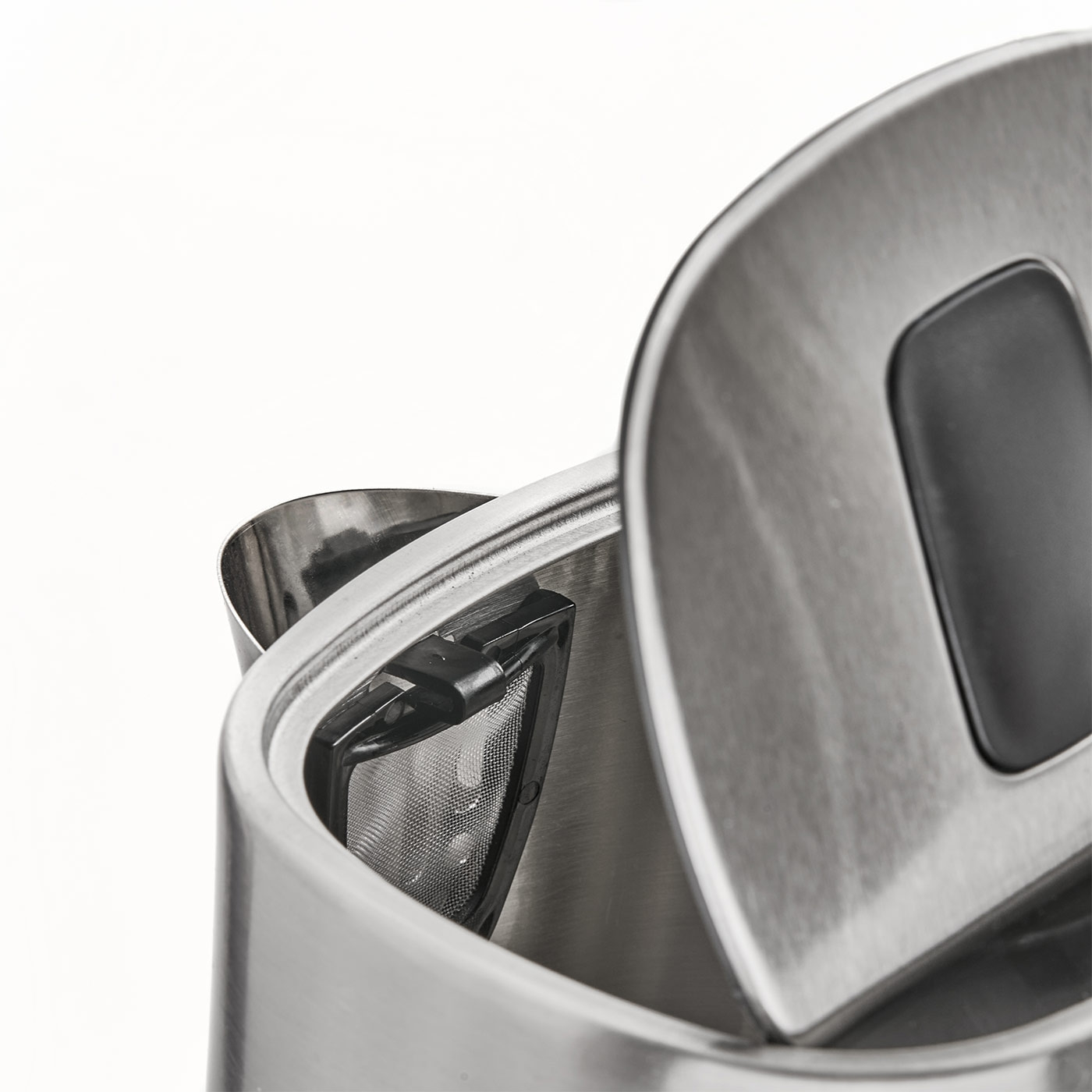 Close-up of a stainless steel kettle with an open lid and tea infuser.