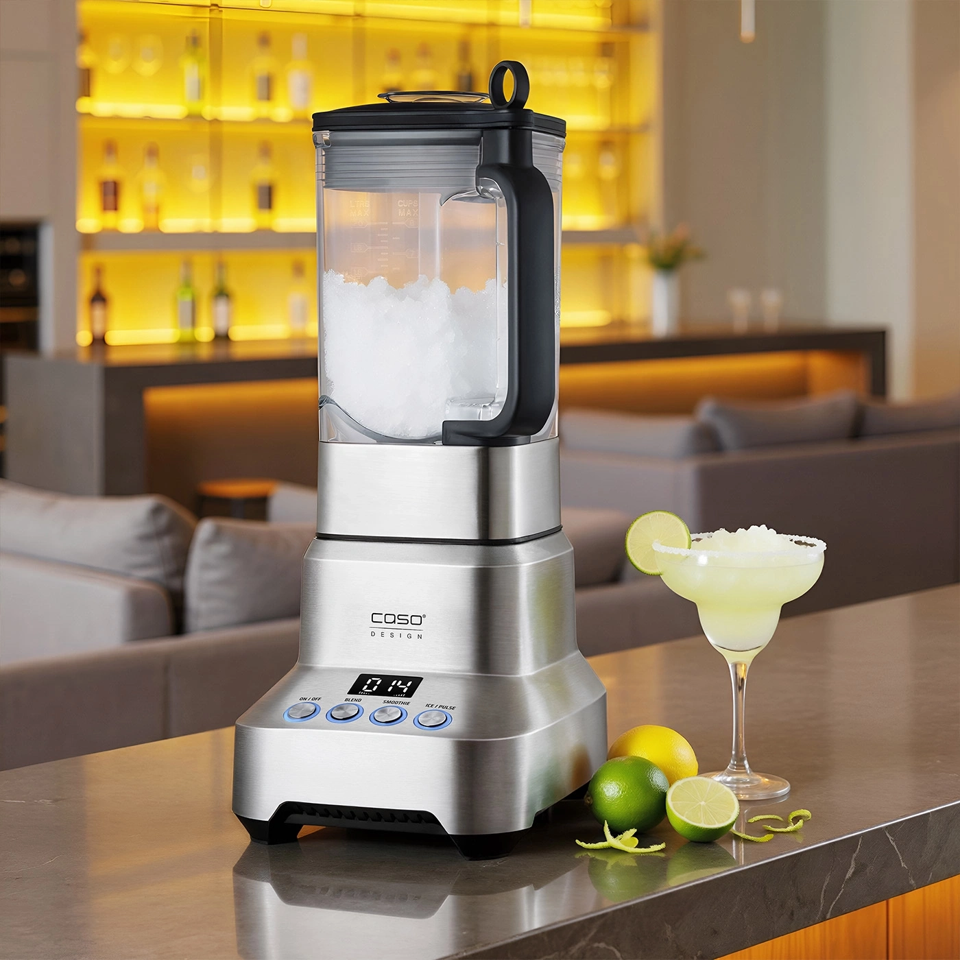 A sleek stainless steel blender is filled with ice, next to a margarita glass with lime.