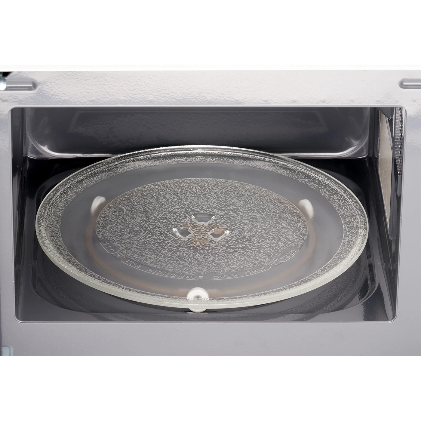 Microwave interior with glass plate. Close-up view. The appliance is clean.