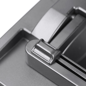 Close-up of a silver lever mounted on a gray surface, with a blurred background.