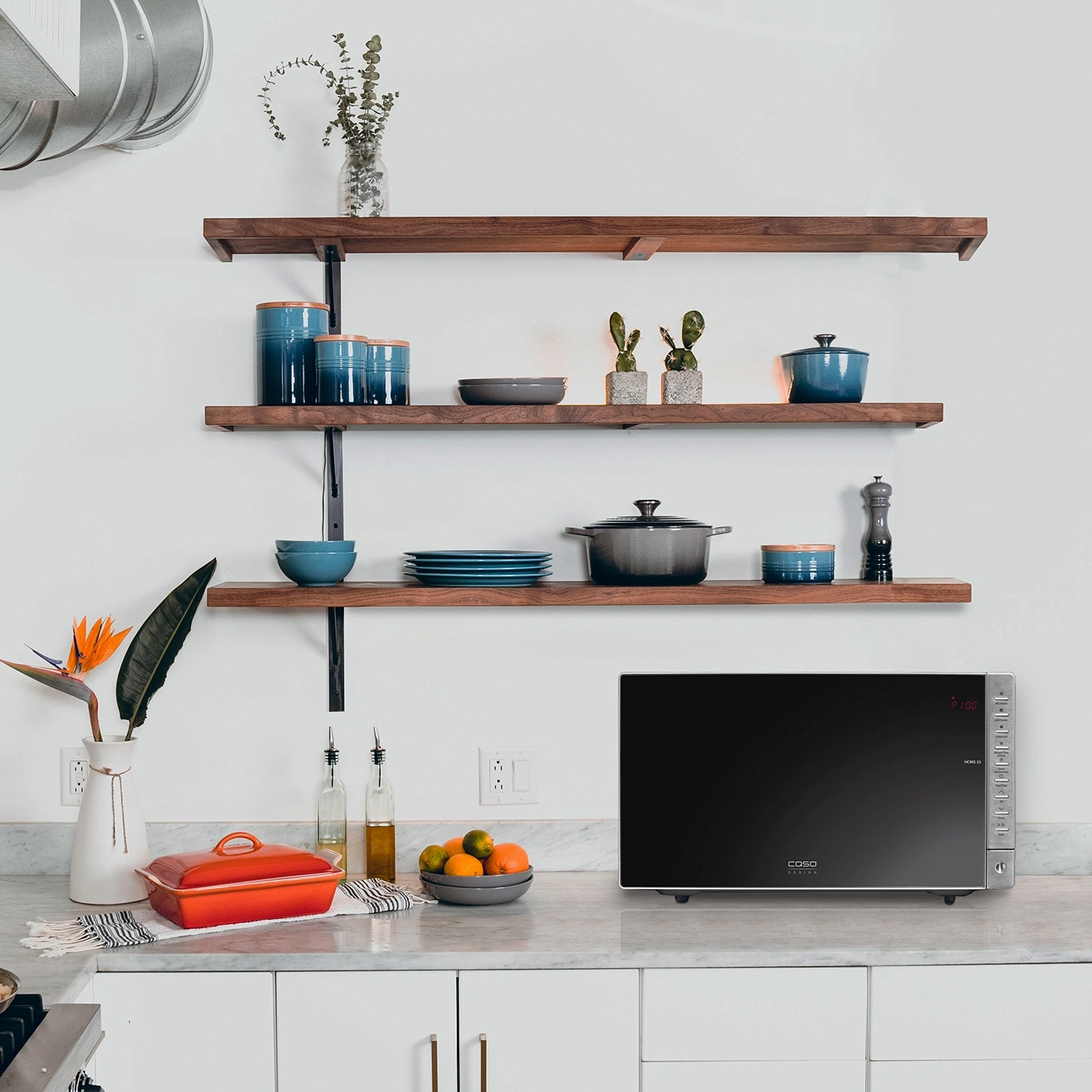 Kitchen with microwave, shelves, and decor. Modern design and aesthetic.