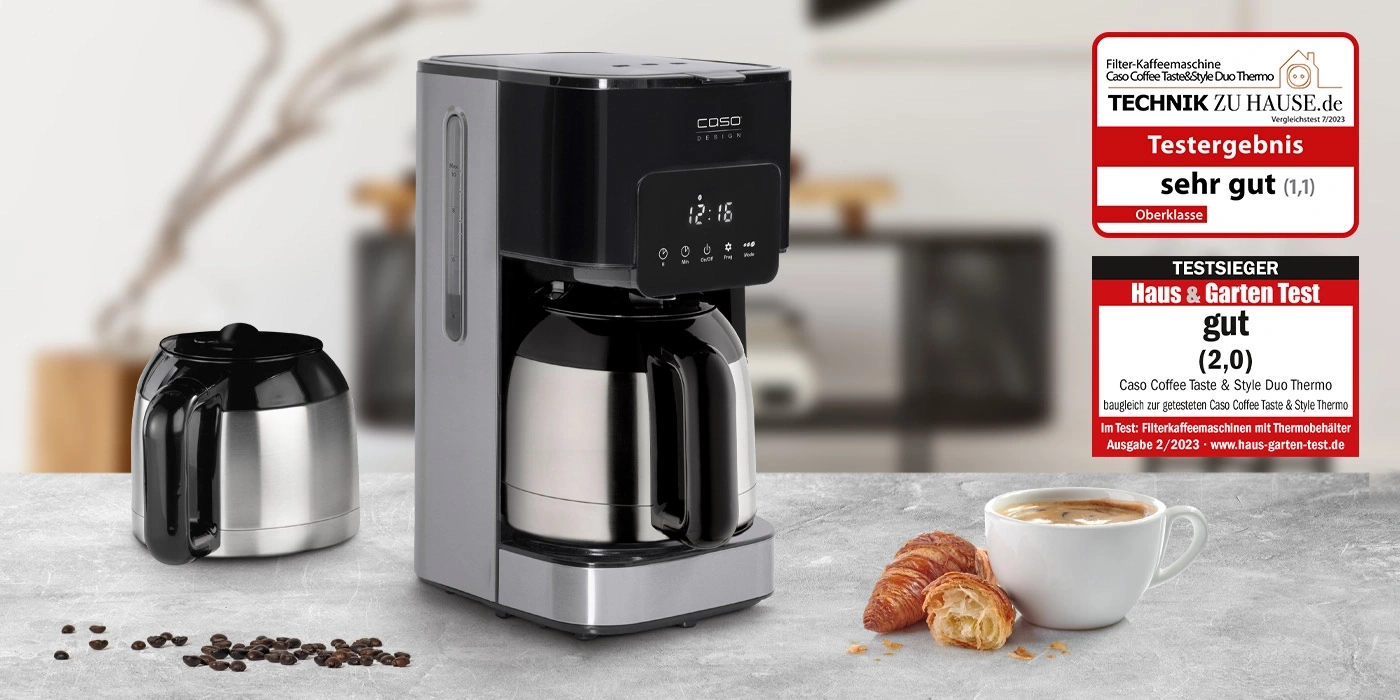 Coffee machine with 'very good' and 'good' test results, croissant and coffee