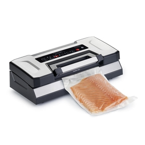 Vacuum sealer with salmon in a plastic bag, ready to be sealed.