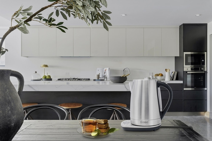 Kitchen with kettle, tea, and cake on a wooden table