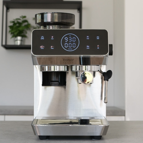 A modern silver espresso machine with a digital display and buttons.