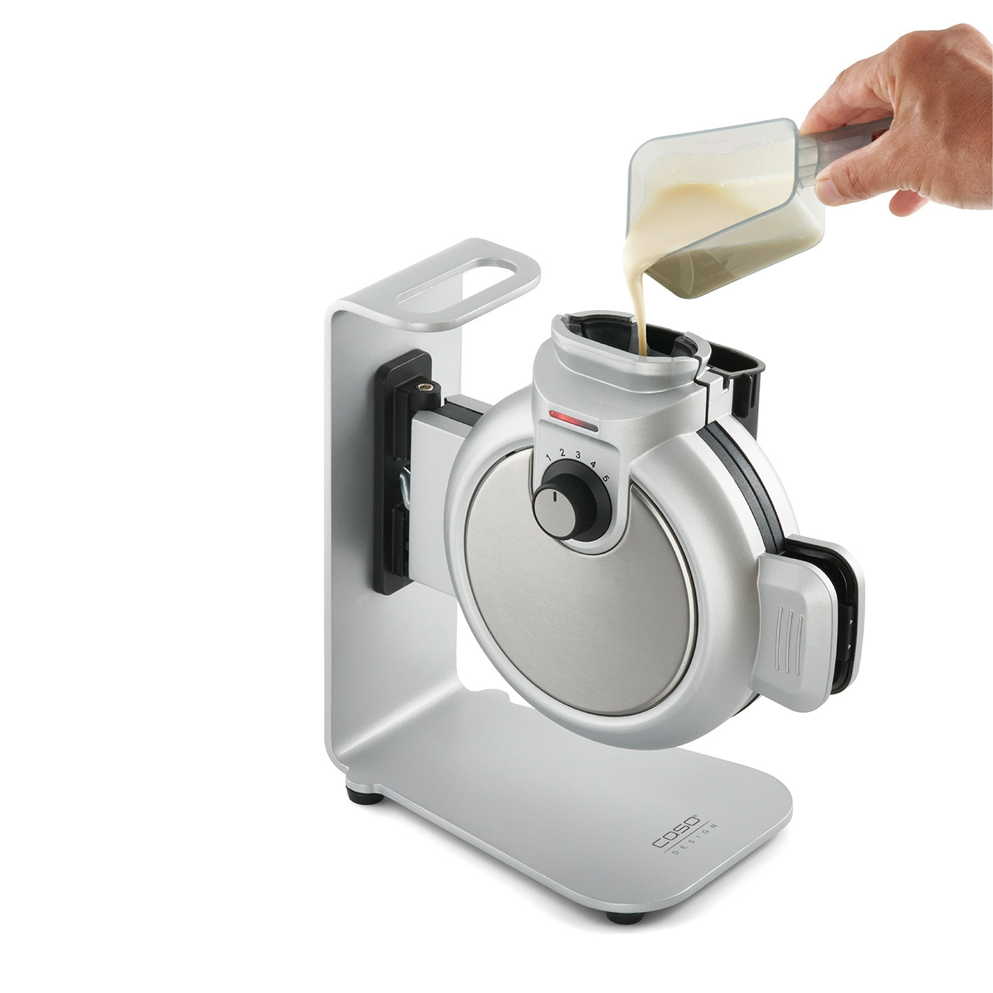 Waffle iron being filled with batter, silver appliance, hand, pouring, kitchen, food, cooking, breakfast, baking