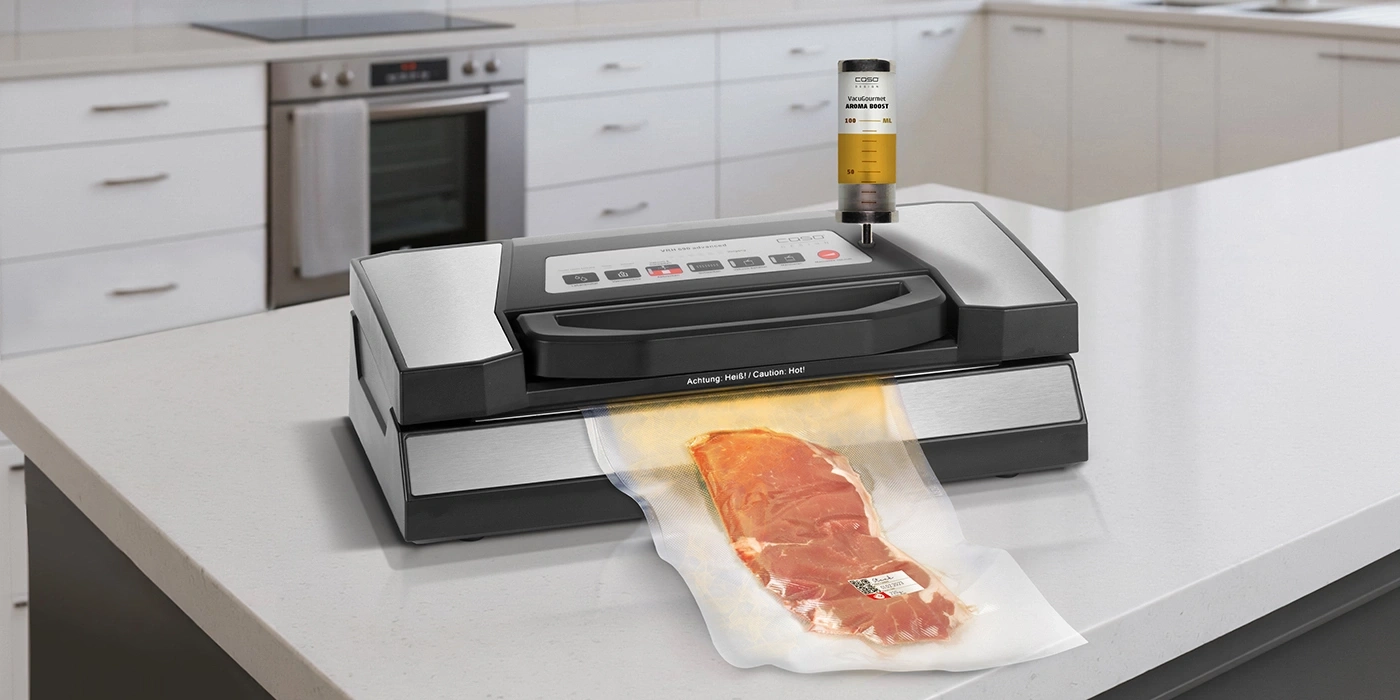 Ein Vakuumiergerät mit Fleisch in einem Beutel auf einer Arbeitsplatte in einer Küche.