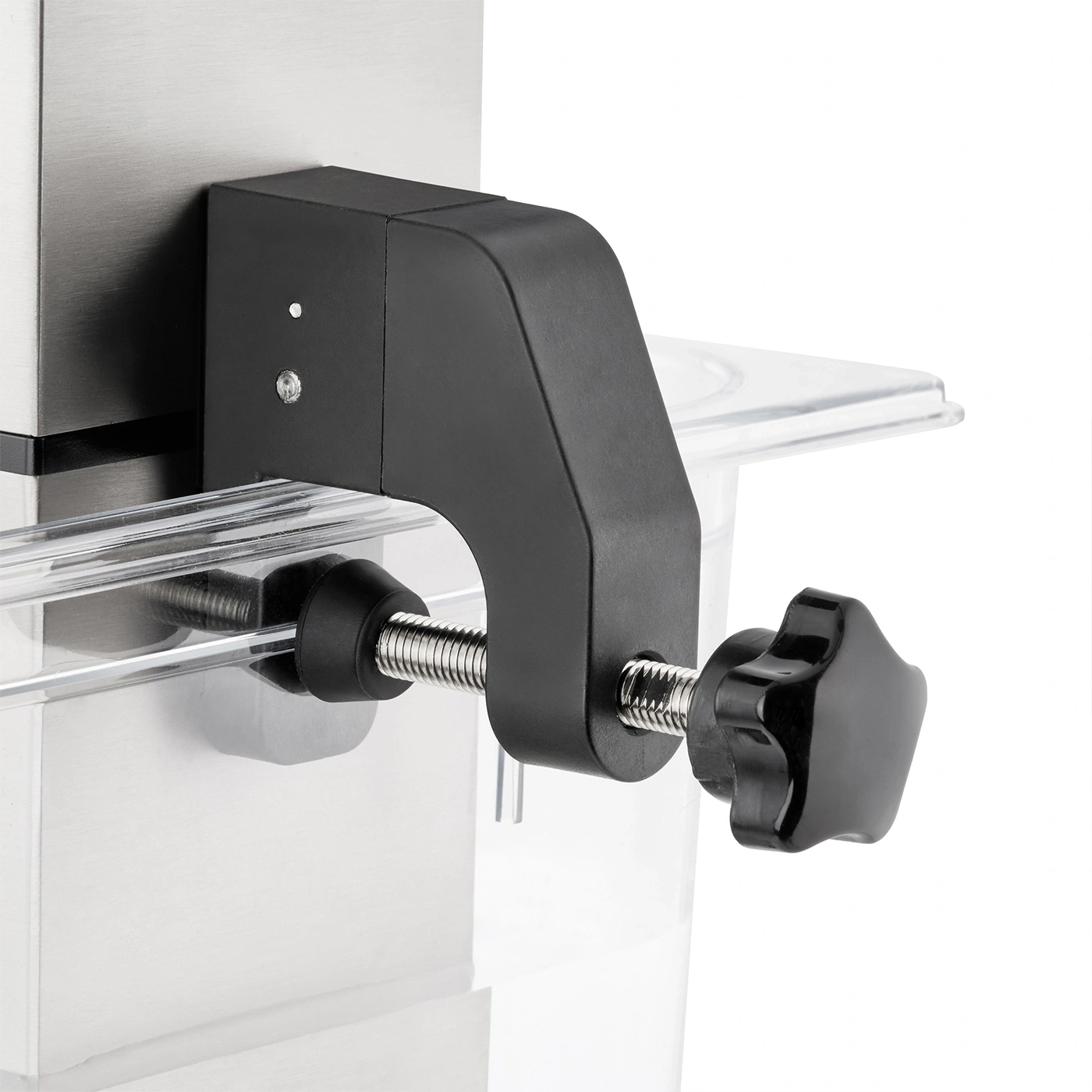 Black vise on a machine with transparent container and star knob for adjustment.