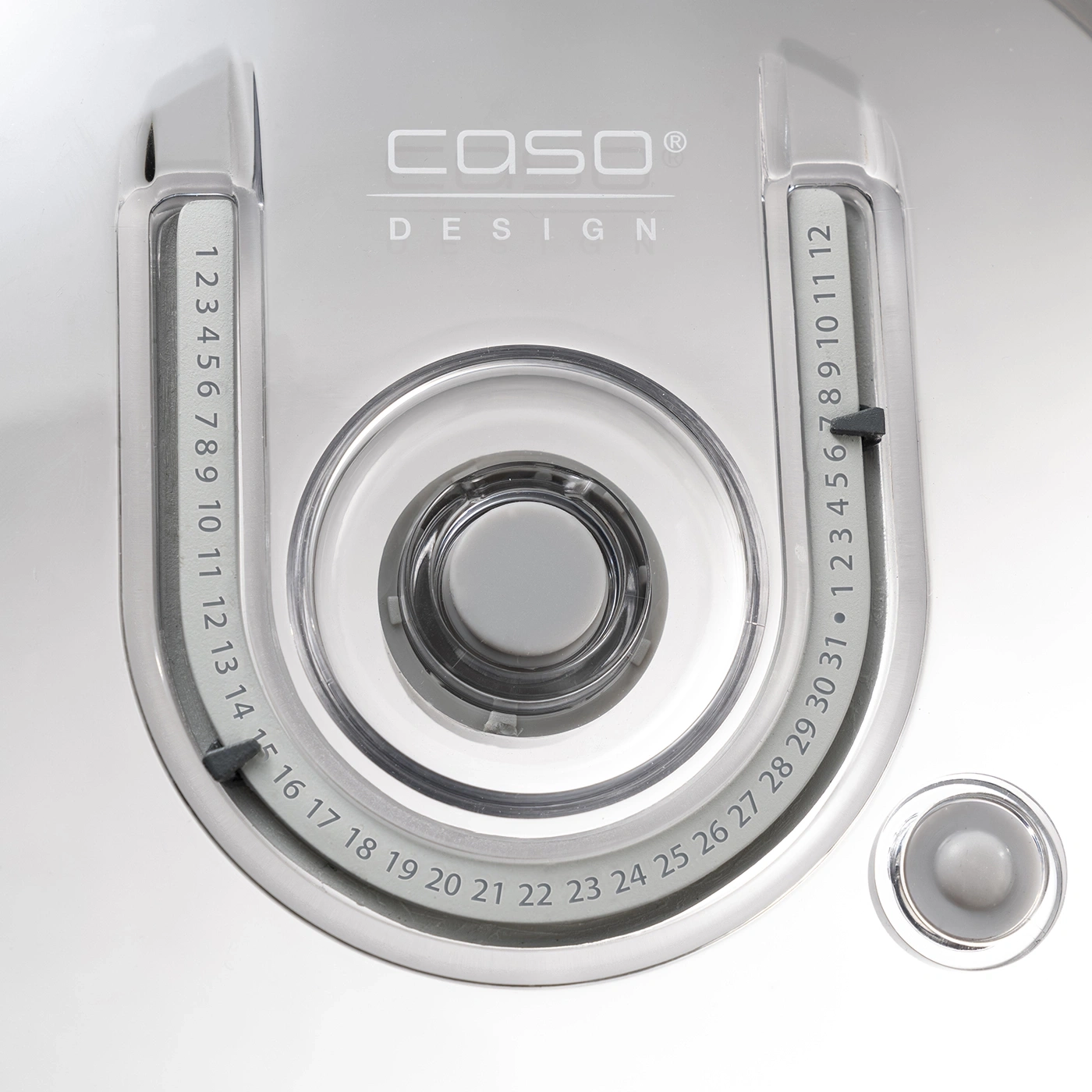 Gray device with numbers and buttons, CASO Design, close-up shot, detail shot.
