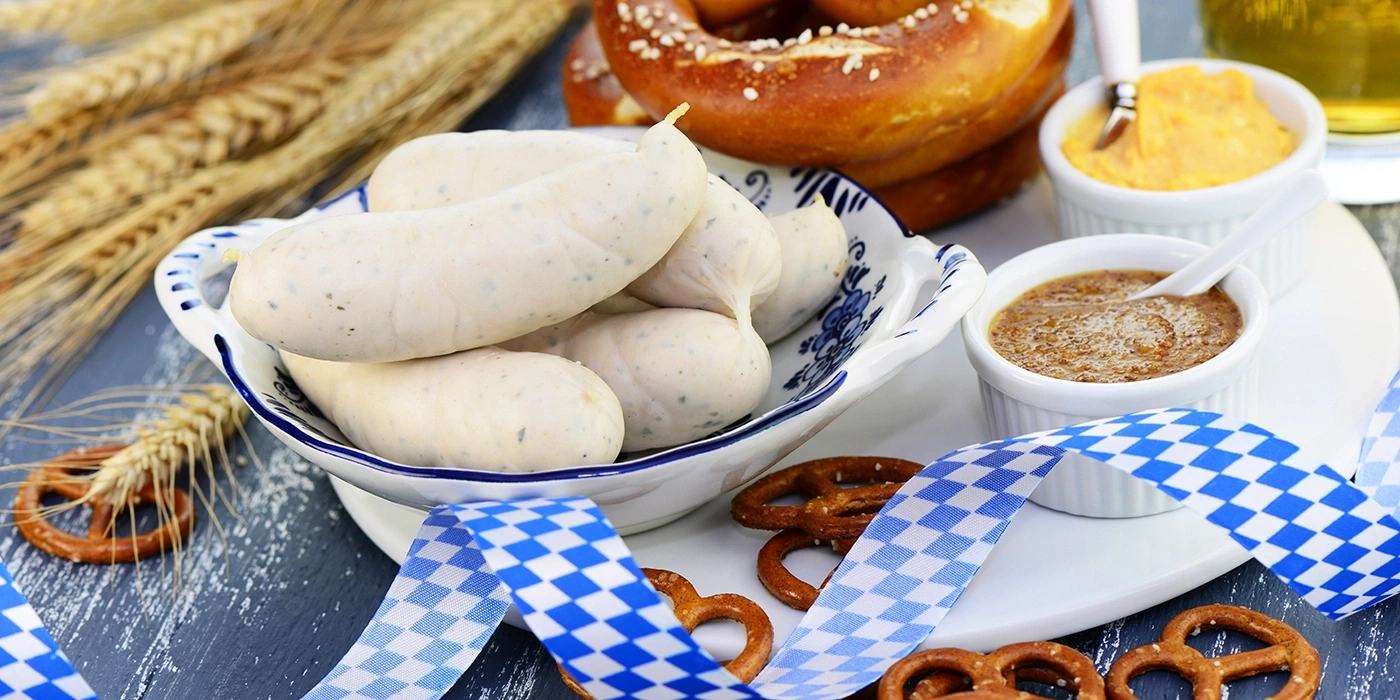 White sausages, pretzels, mustard, blue and white ribbon, Oktoberfest food, close-up