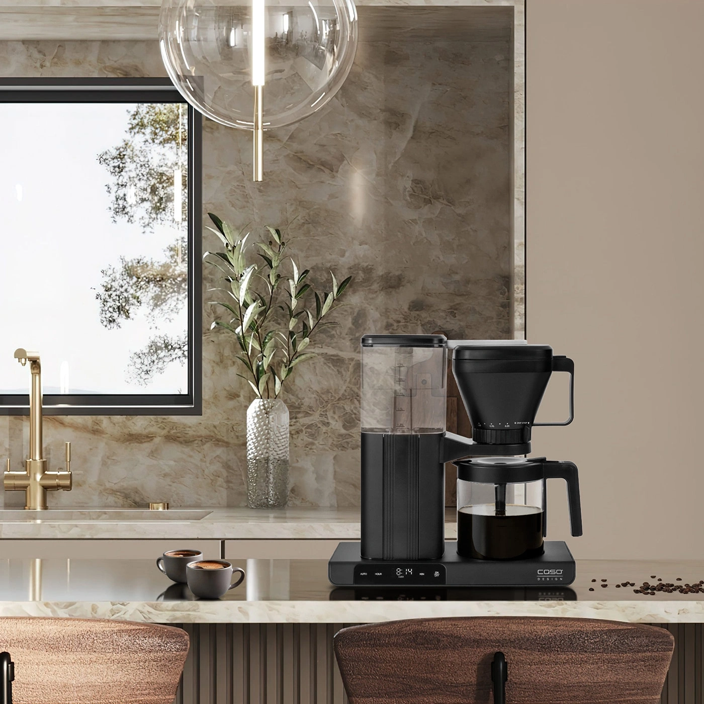 A modern coffee maker in a stylish kitchen with marble and wood.